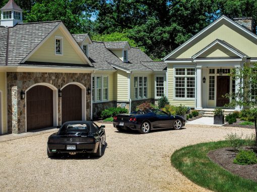 Yellow Breezy Oaks house with cars parked in the driveway