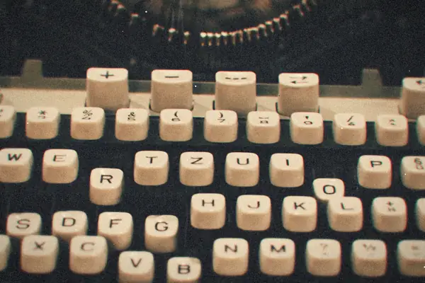 Close-up of the plain white keys on an old manual typewriter.
