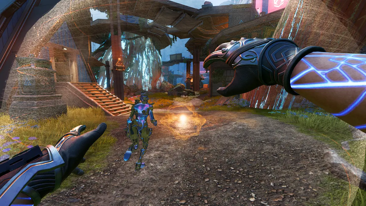 A first-person view in Apex Legends of a character's gloved hands on a sunny grassy path near wooden stairs.