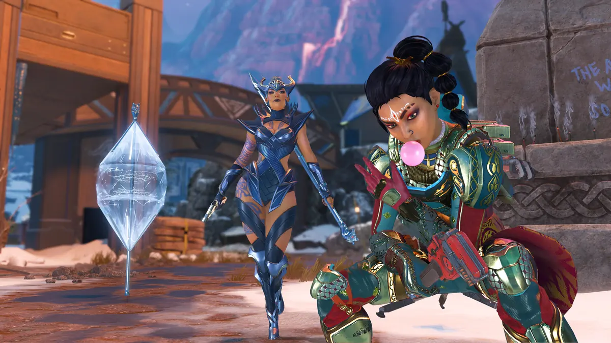 Two Apex Legends characters in ornate armor standing in a snowy outpost.