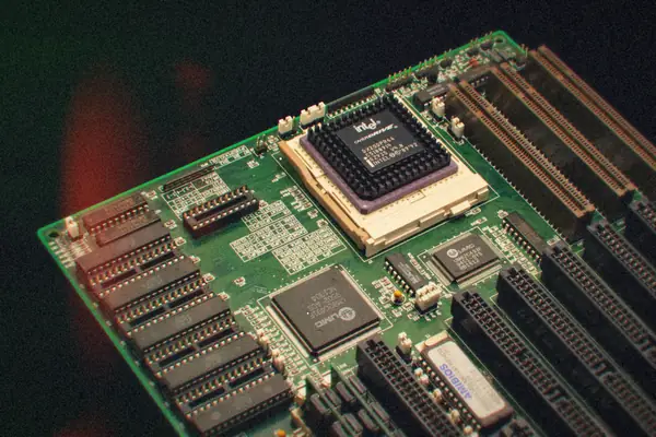 Close-up of a vintage computer motherboard with its processor and memory slots.
