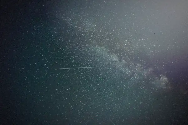 The Milky Way stretched across a dark, starry night sky.