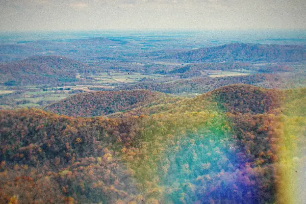 Rolling Blue Ridge mountains in Virginia covered in fall color under a wide sky.