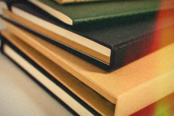 A neat stack of hardcover books showing their bindings.