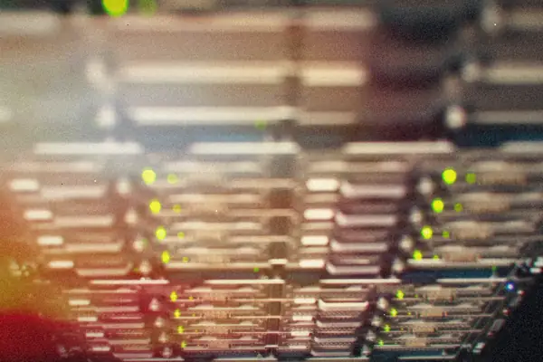 Rows of rack-mounted equipment with small green status lights.