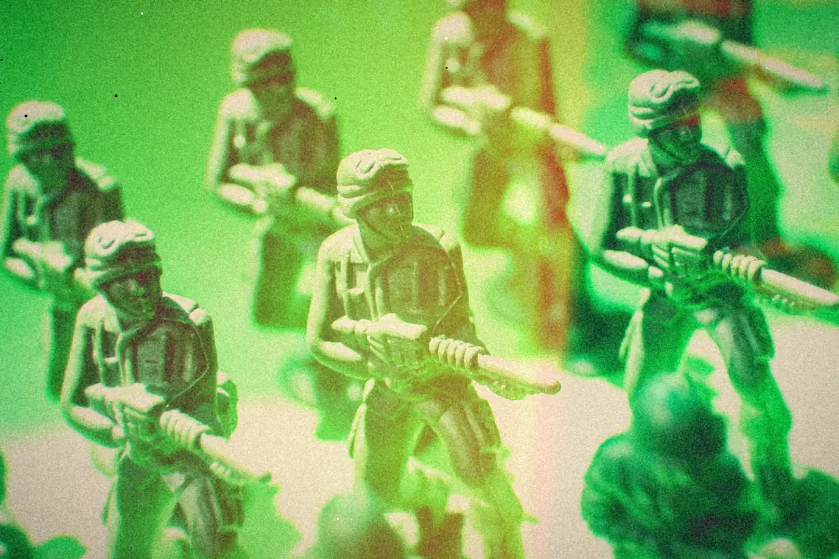Green plastic toy soldiers lined up in formation.